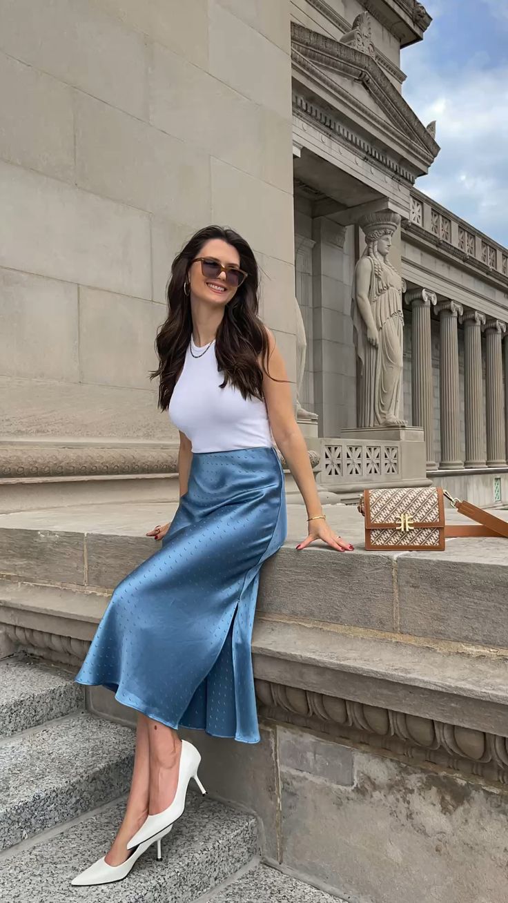 White sleeveless top with a blue silk midi skirt